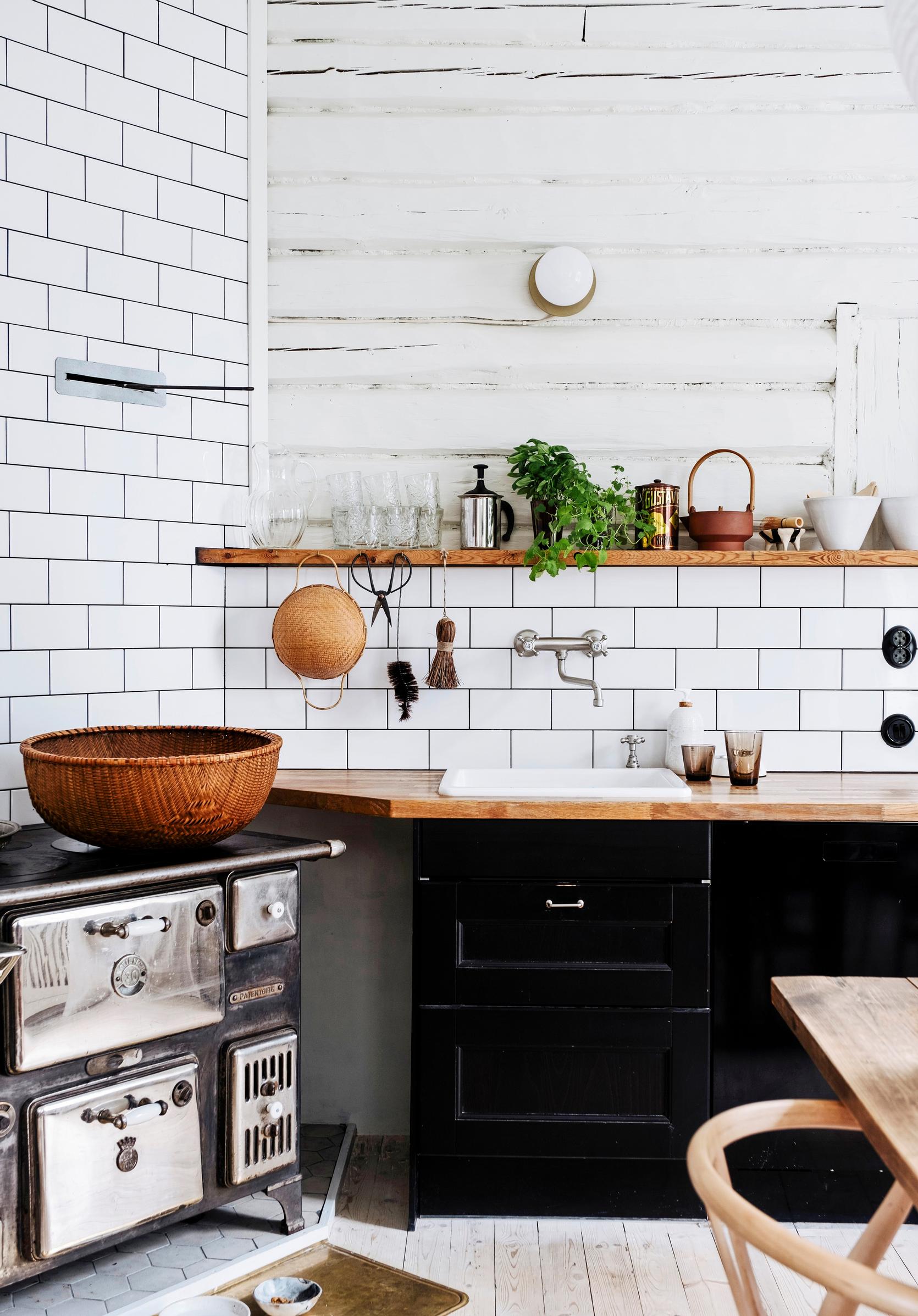 The kitchen’s log wall is painted white with Uula linseed oil paint.