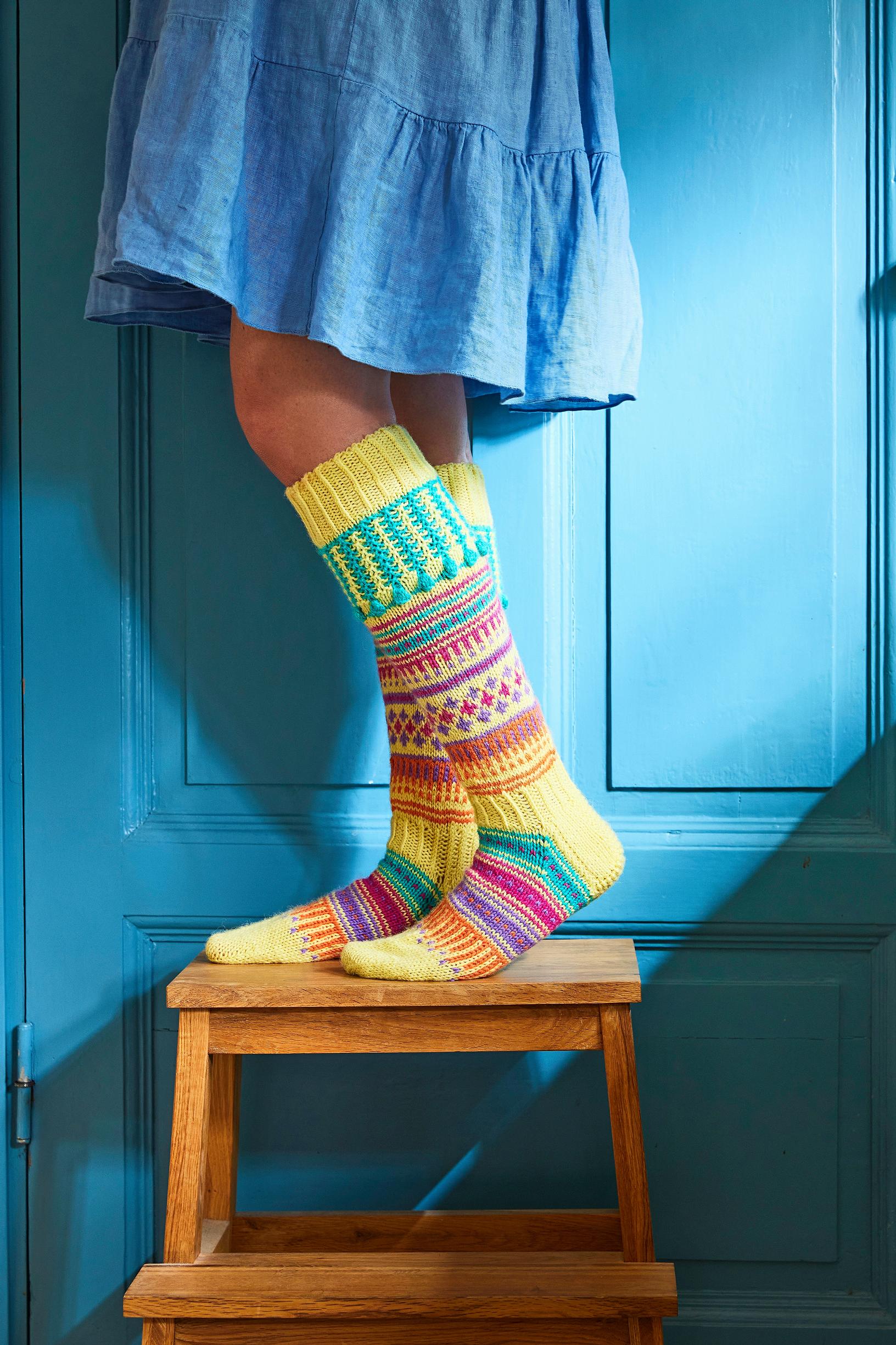 The long-legged Hullabaloo socks burst with color and are easy to knit