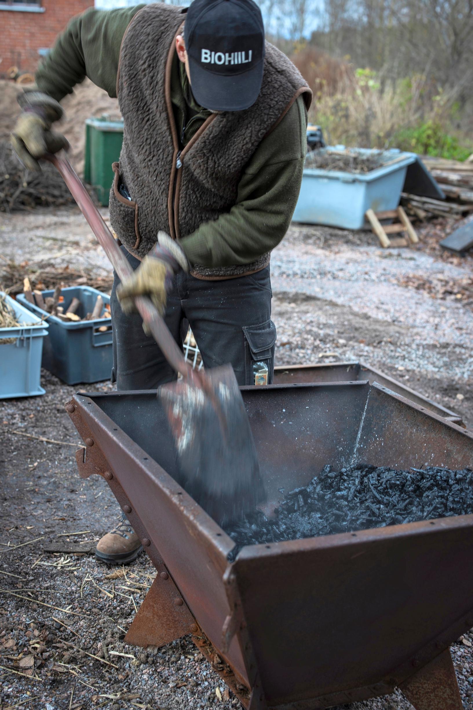 breaking up biochar with a shovel