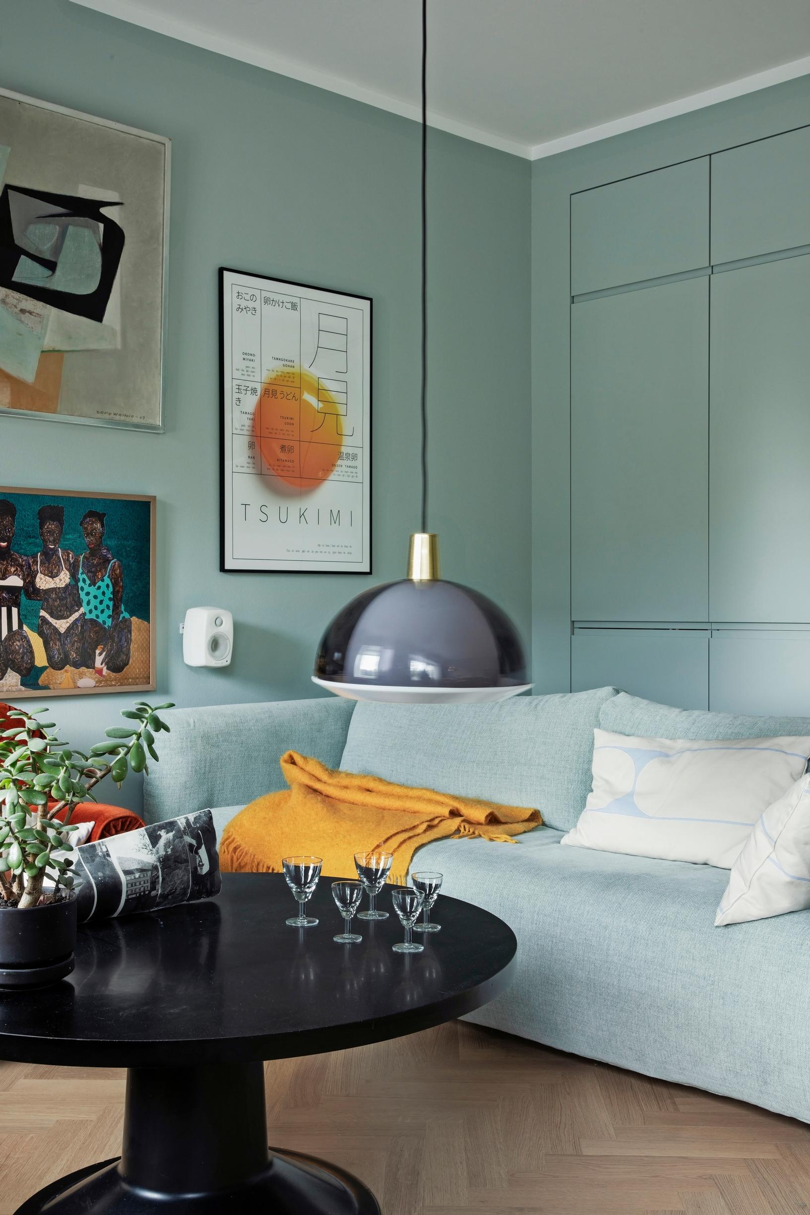 A wall-mounted storage unit and sofa blending into the wall color