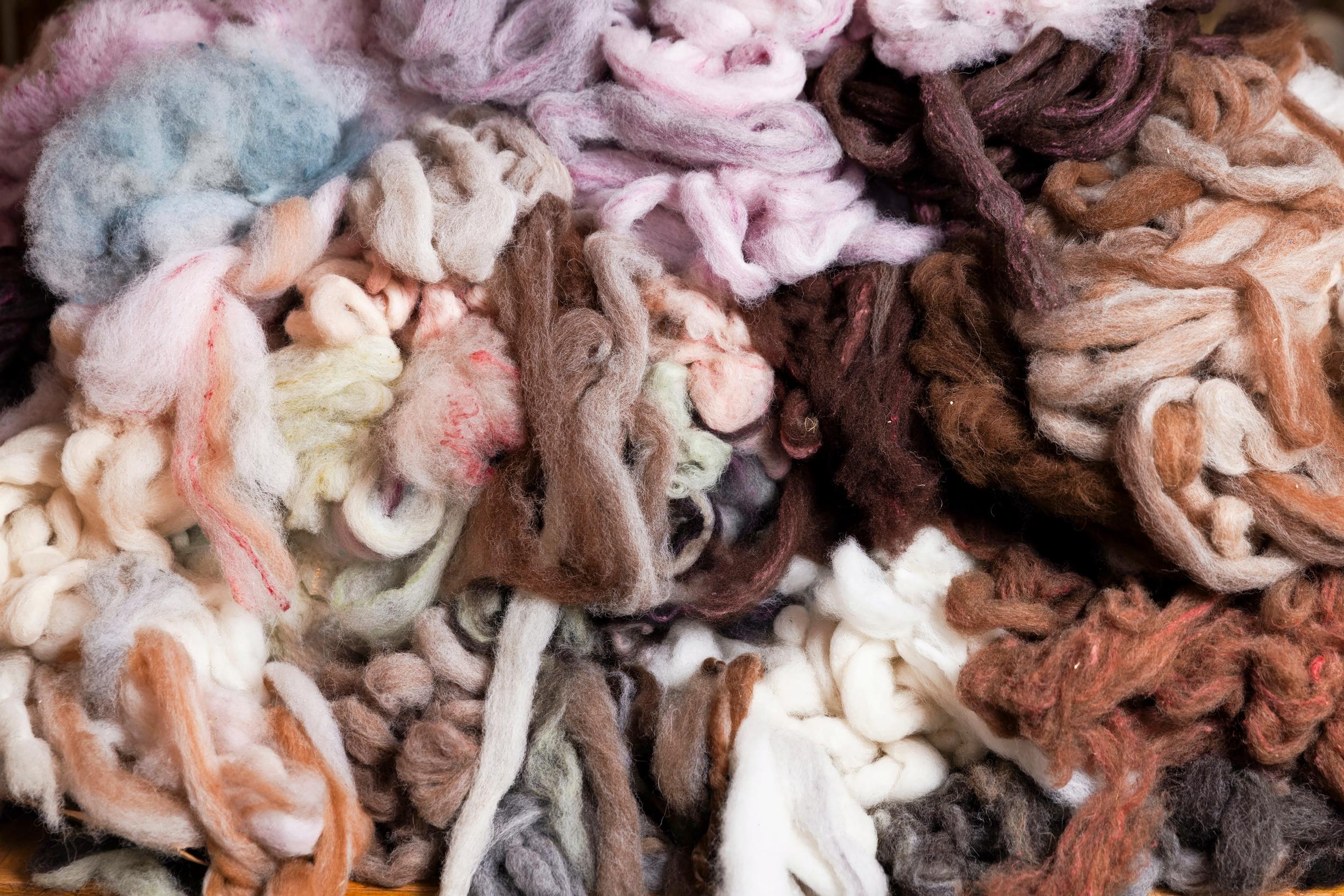 skeins of wool in various colors scattered around