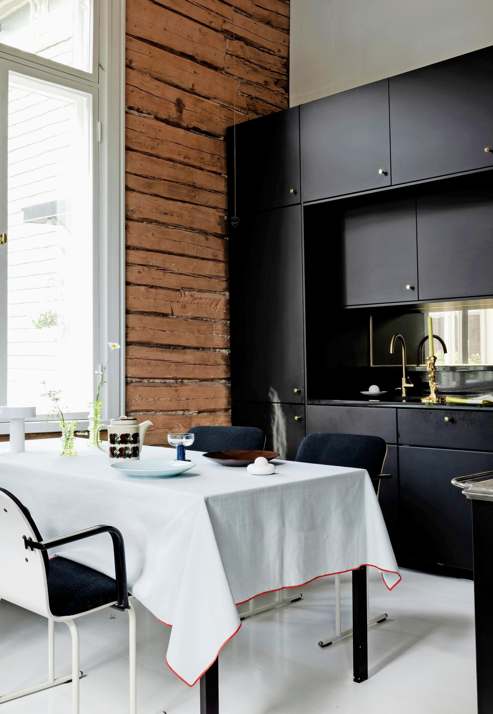 The kitchen and dining set in front of the window.