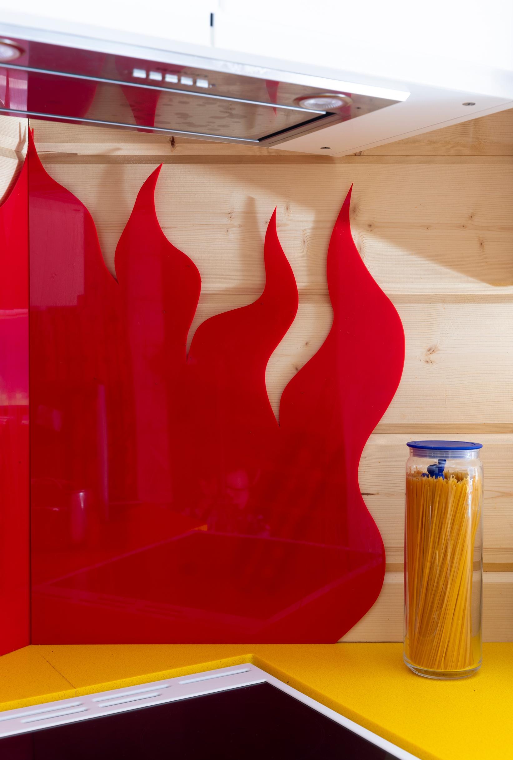 Red plastic flames above the stove