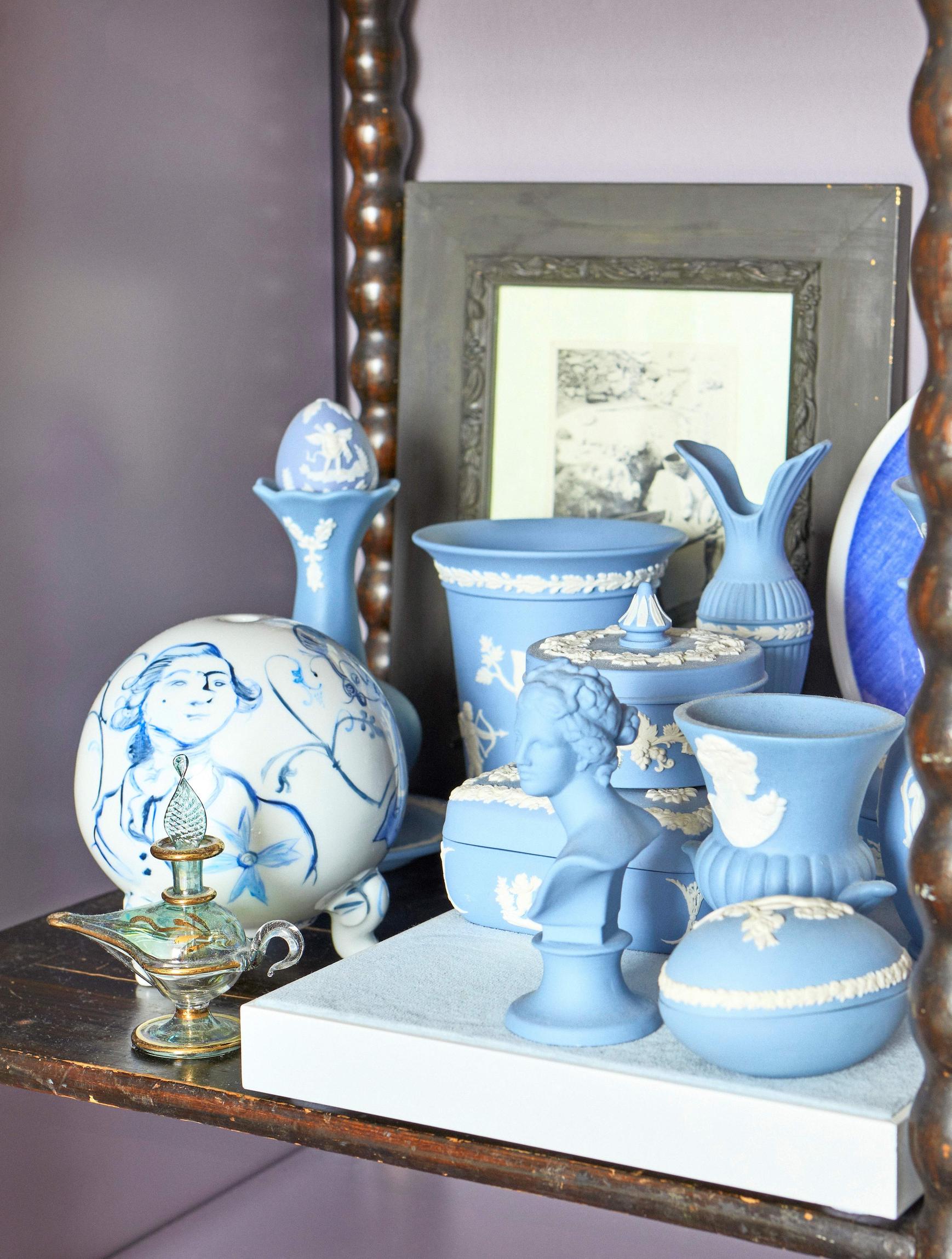 blue-and-white porcelain items, a book, and a painting