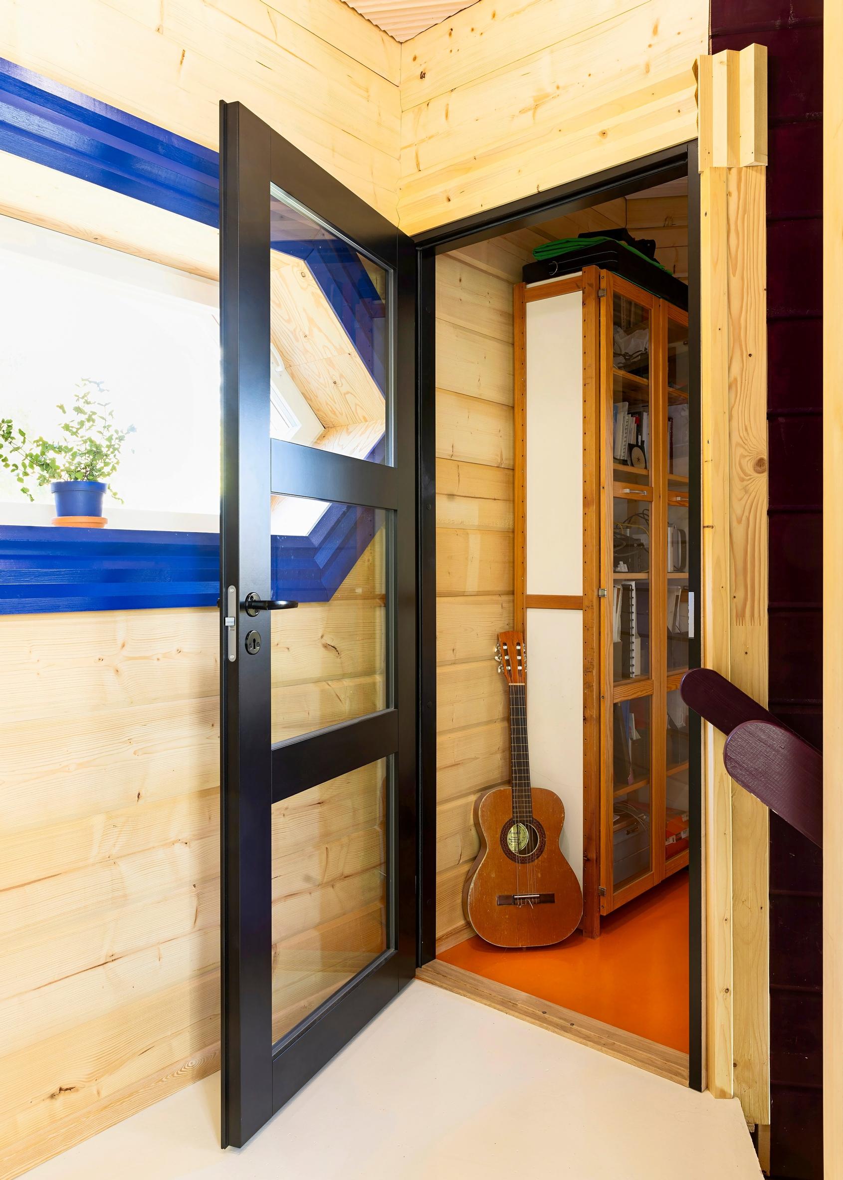The upstairs black-framed glass door