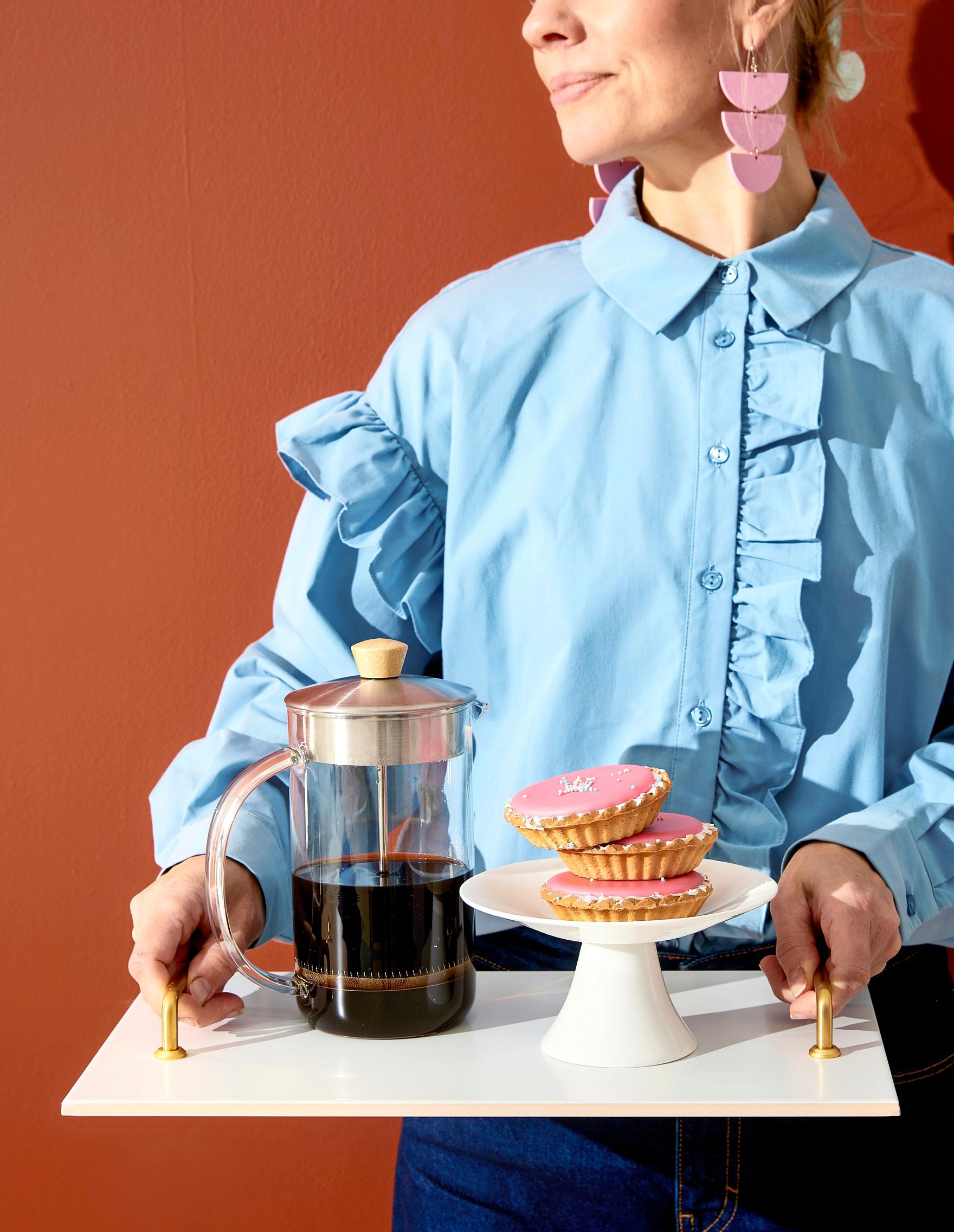 Coffee pot and pastries on a tile tray.